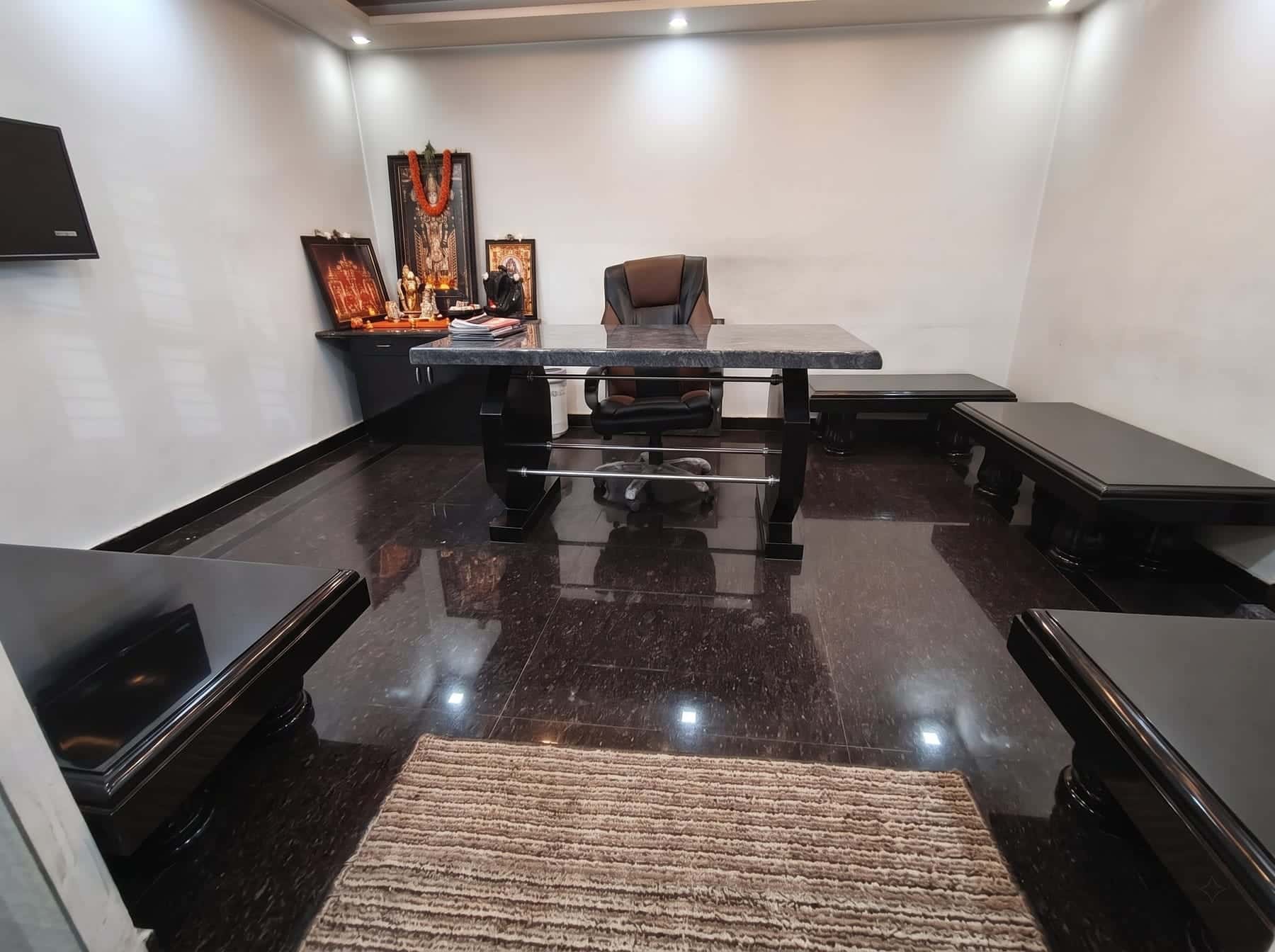 Interior room with polished dark granite flooring and granite furniture